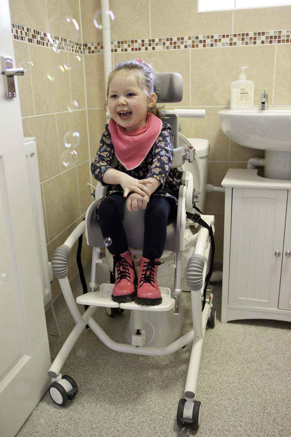 Adjustable Flamingo High Low Chair offers bathing and toileting independence for Tia and her family